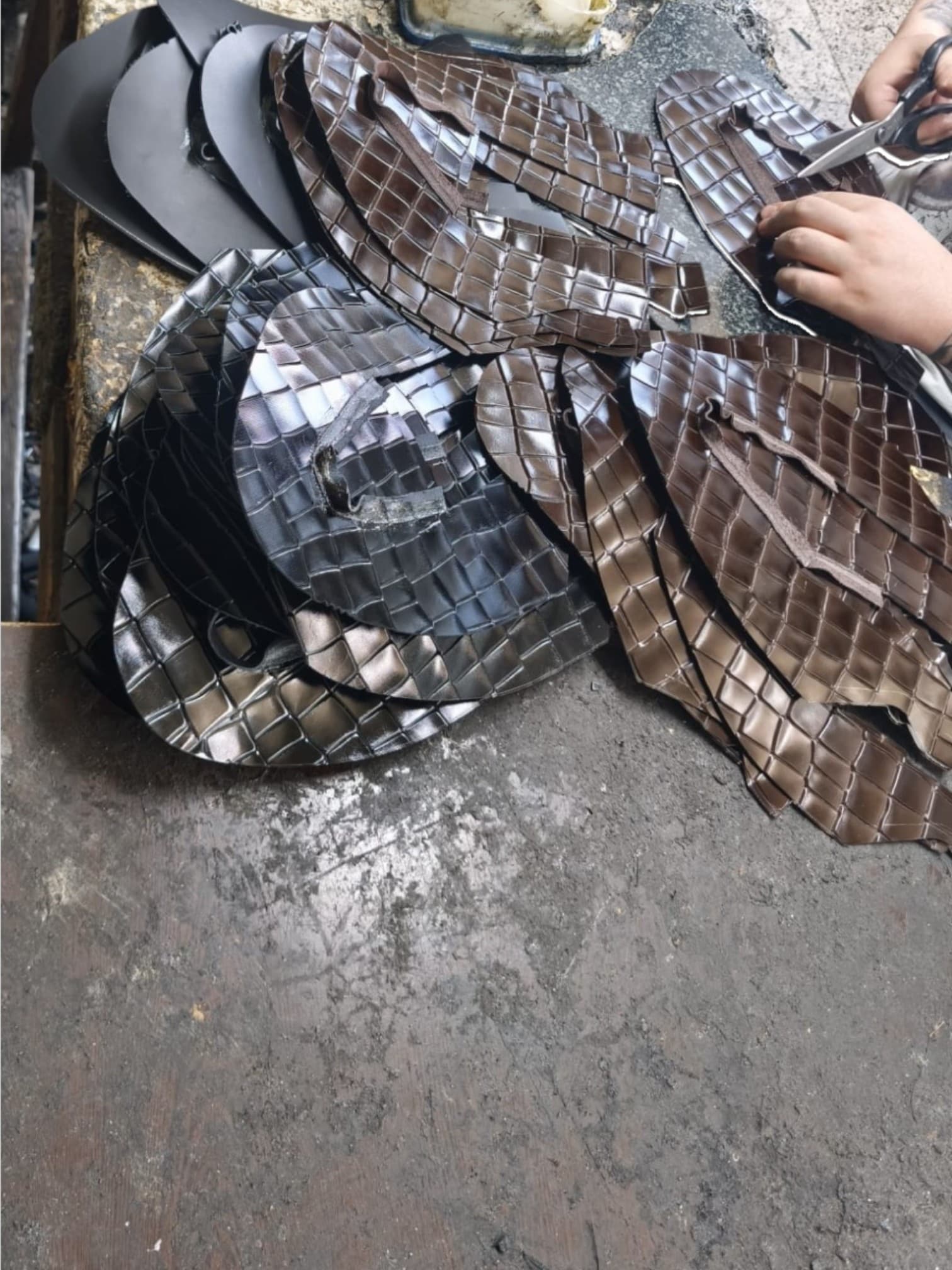 Cutting croc-embossed leather pieces by hand