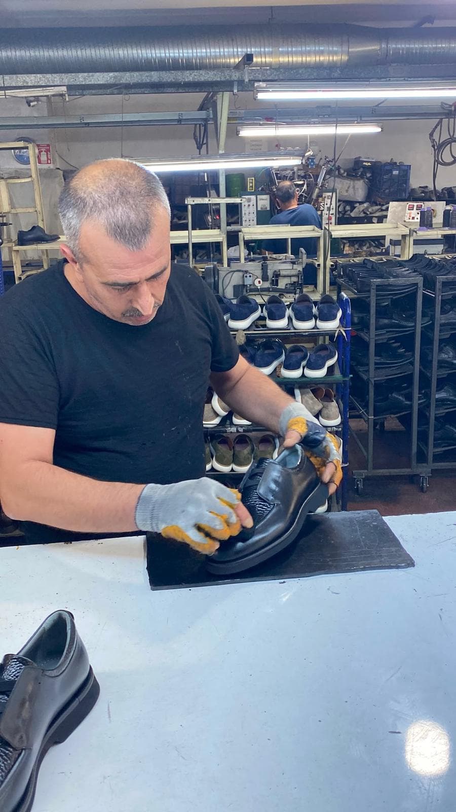 A craftsperson finishing a shoe in the Gaziantep workshop